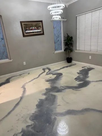 a view of a livingroom with a chandelier fan and kitchen view