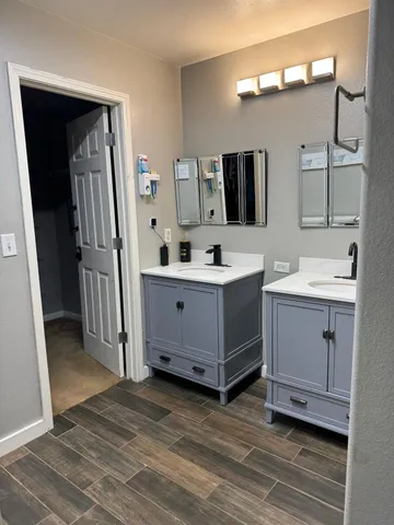 a bathroom with a double vanity sink and mirror