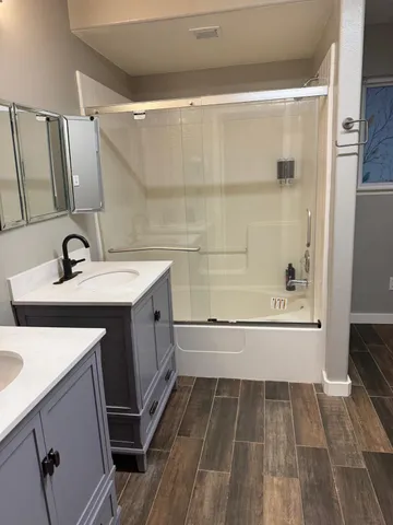 a bathroom with a sink a toilet and shower