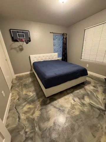 a bedroom with a bed and window