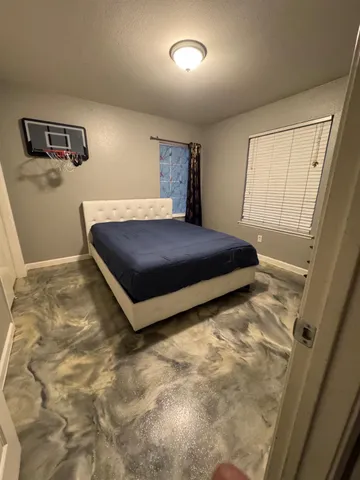 a room with a bed and window