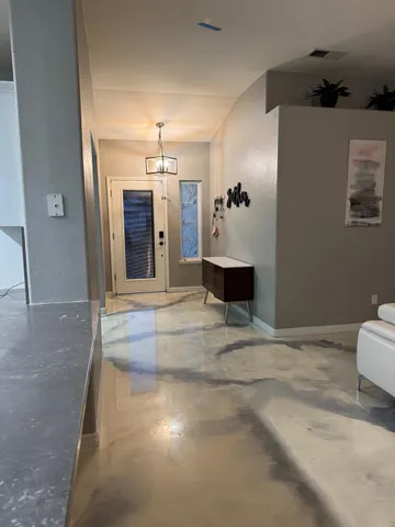 a view of a hallway with a chandelier