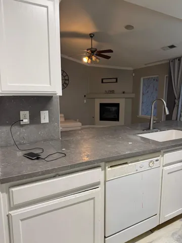 a kitchen with a sink stainless steel appliances and cabinets