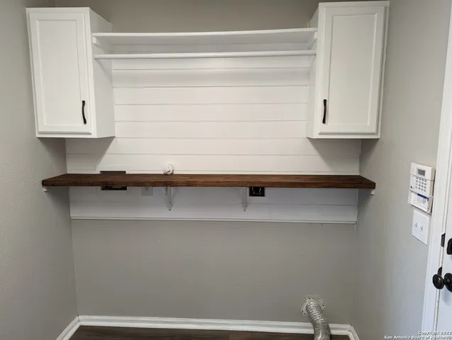 a view of balcony with wooden floor and fence