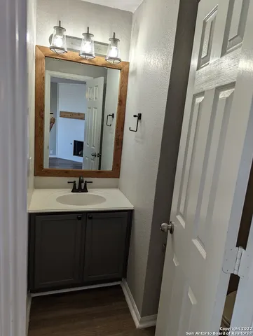 a bathroom with a sink vanity and a mirror