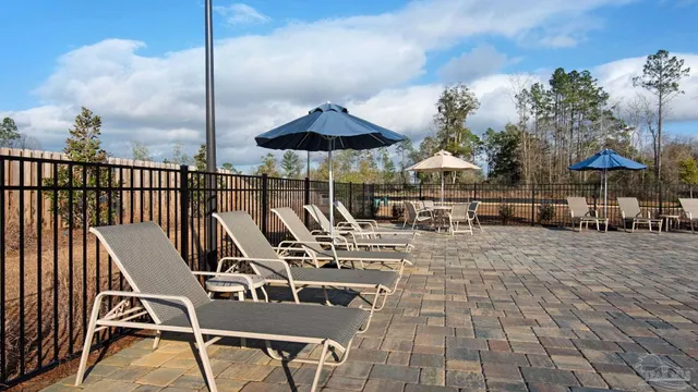 a view of a patio with a table chairs and backyard
