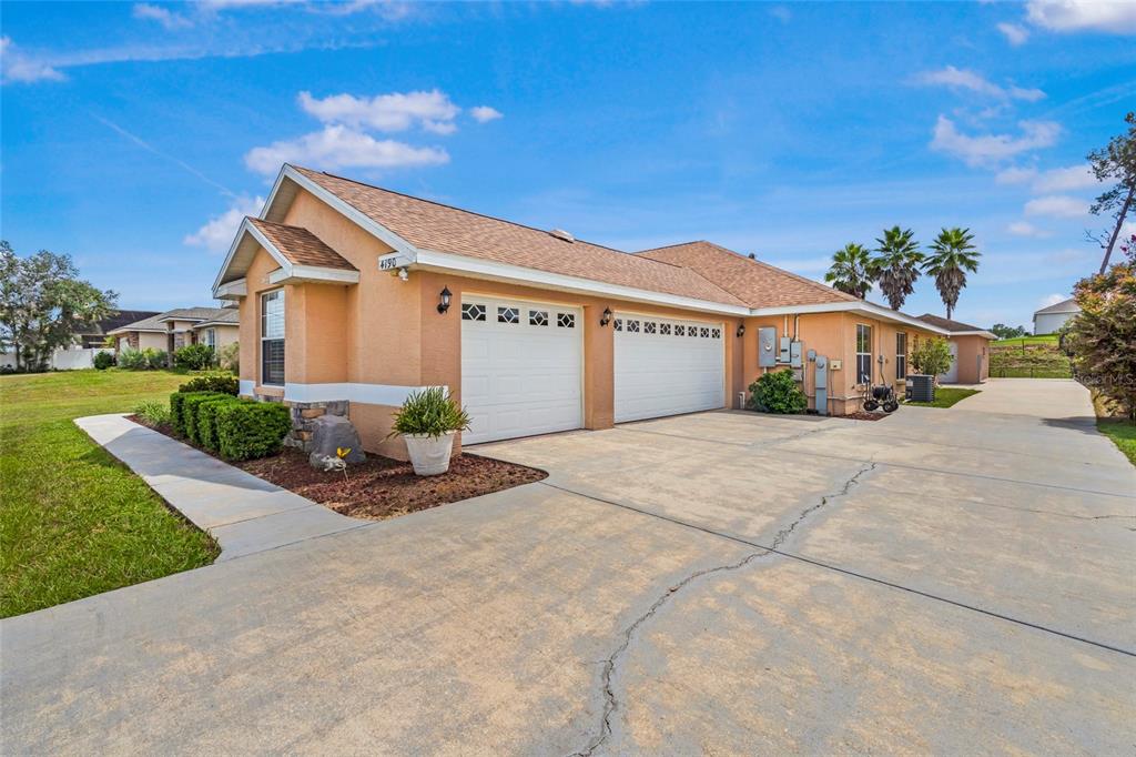 4190 Southwest 103rd Street Road Ocala, FL 34476 - Photo 15 of 55 a front view of a house with a yard and garage