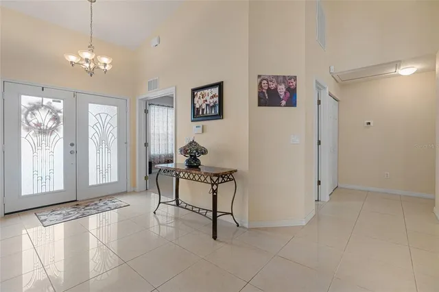 a view of a dining room with furniture a chandelier and wooden floor