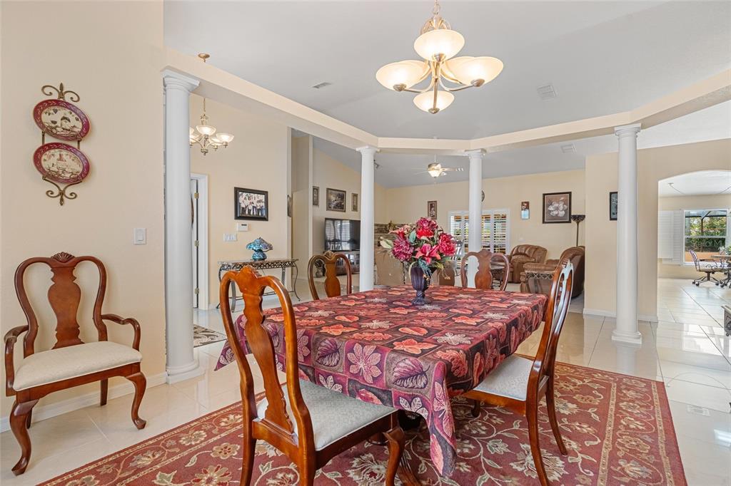 4190 Southwest 103rd Street Road Ocala, FL 34476 - Photo 19 of 55 a view of a dining room with furniture a chandelier and wooden floor