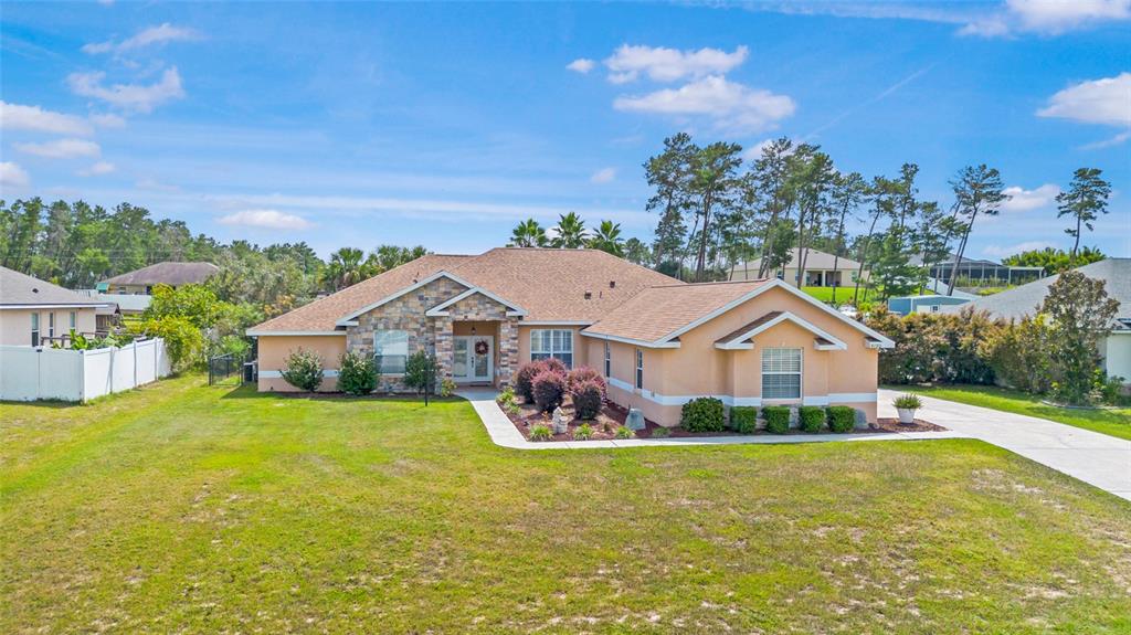 4190 Southwest 103rd Street Road Ocala, FL 34476 - Photo 2 of 55 a front view of a house with garden