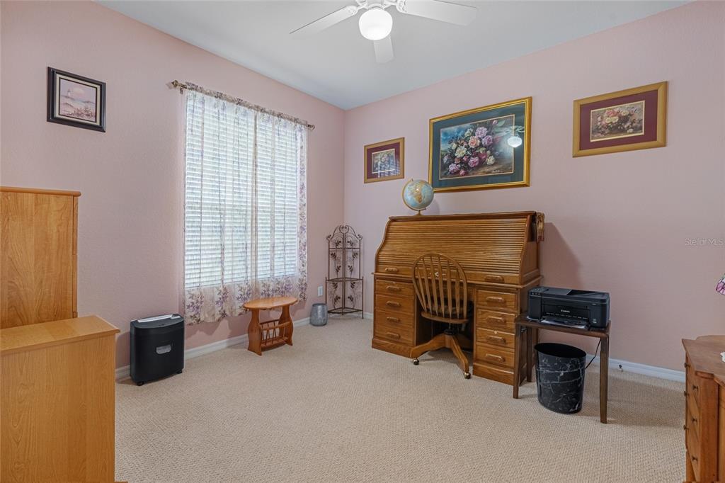 4190 Southwest 103rd Street Road Ocala, FL 34476 - Photo 21 of 55 a bedroom with a bed and a chandelier