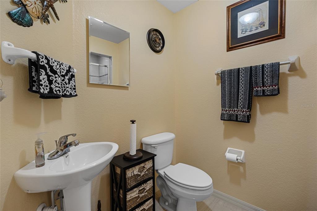 4190 Southwest 103rd Street Road Ocala, FL 34476 - Photo 23 of 55 a bathroom with a toilet a sink and mirror