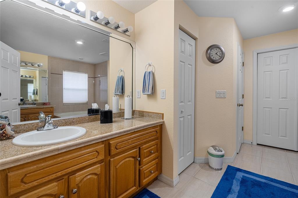 4190 Southwest 103rd Street Road Ocala, FL 34476 - Photo 29 of 55 a spacious bathroom with a granite countertop sink toilet and shower