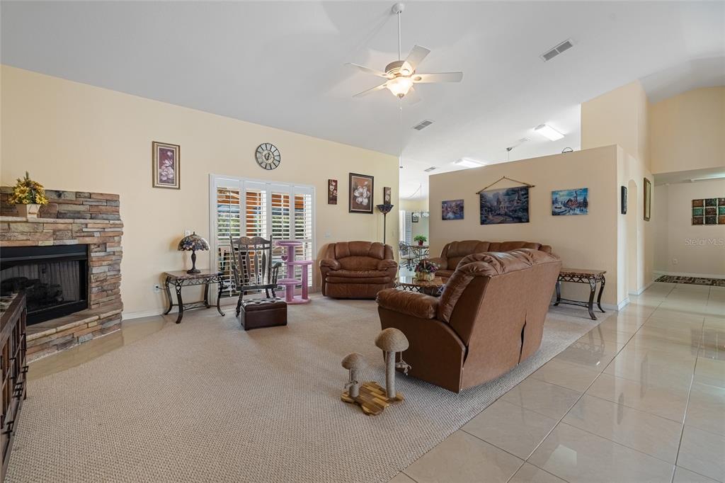4190 Southwest 103rd Street Road Ocala, FL 34476 - Photo 30 of 55 a living room with furniture and a fireplace