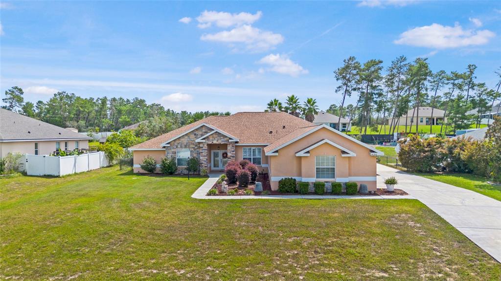4190 Southwest 103rd Street Road Ocala, FL 34476 - Photo 3 of 55 a front view of a house with garden
