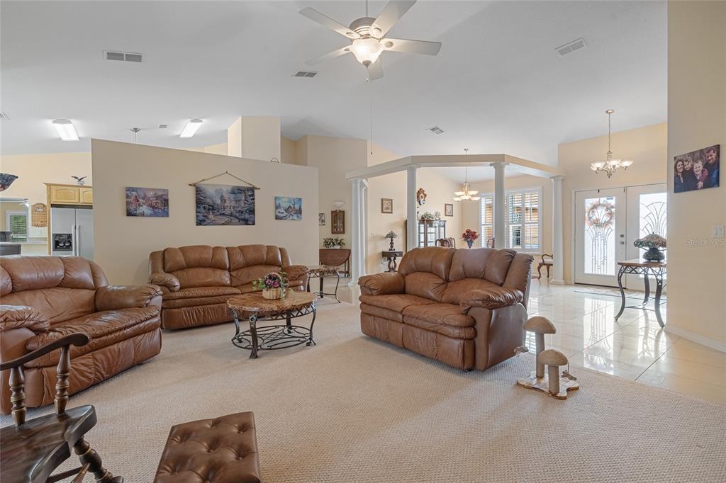 4190 Southwest 103rd Street Road Ocala, FL 34476 - Photo 33 of 55 a living room with furniture and a chandelier