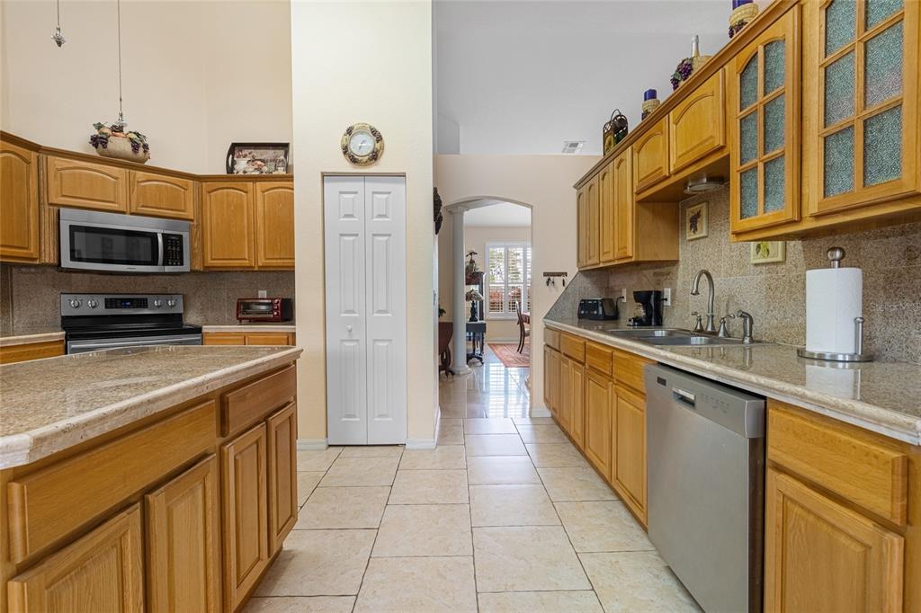 4190 Southwest 103rd Street Road Ocala, FL 34476 - Photo 35 of 55 a kitchen with stainless steel appliances granite countertop a refrigerator and a stove top oven