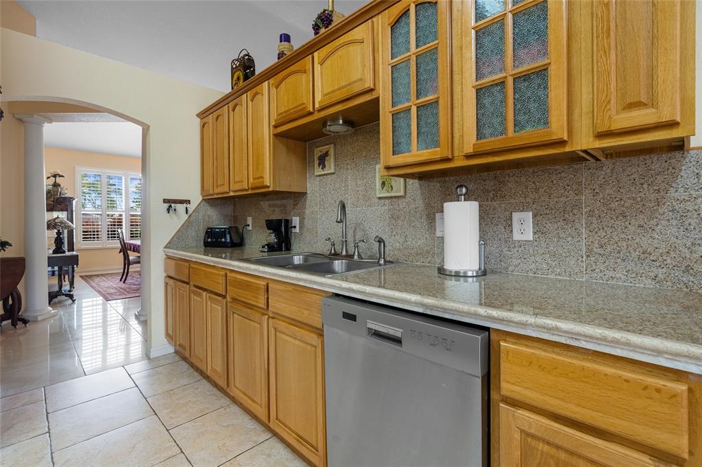 4190 Southwest 103rd Street Road Ocala, FL 34476 - Photo 37 of 55 a kitchen with stainless steel appliances granite countertop a sink and cabinets