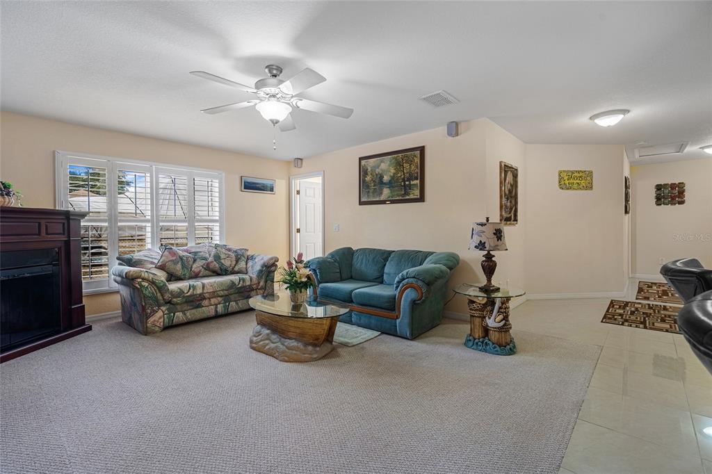 4190 Southwest 103rd Street Road Ocala, FL 34476 - Photo 40 of 55 a living room with furniture and a fireplace