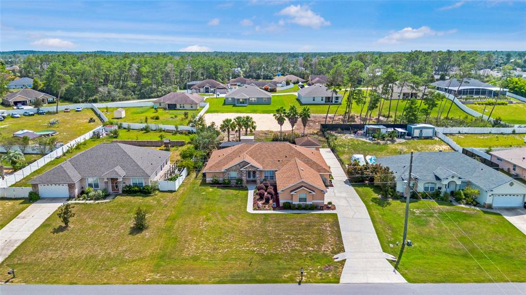 4190 Southwest 103rd Street Road Ocala, FL 34476 - Photo 4 of 55 an aerial view of a house with a swimming pool yard and outdoor seating