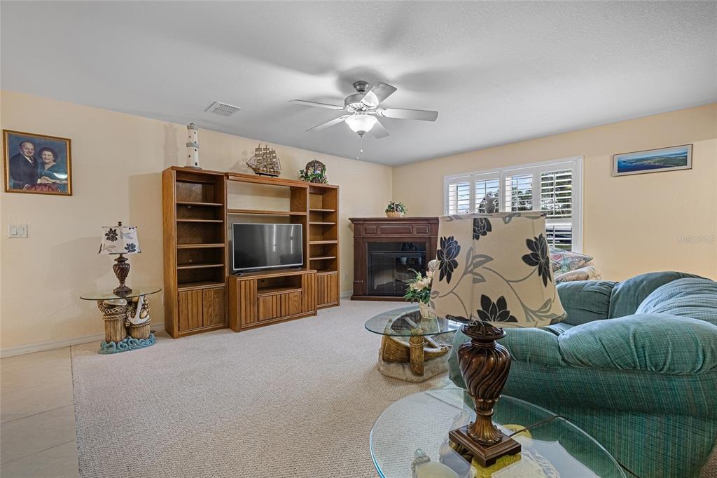 4190 Southwest 103rd Street Road Ocala, FL 34476 - Photo 41 of 55 a living room with furniture and a flat screen tv