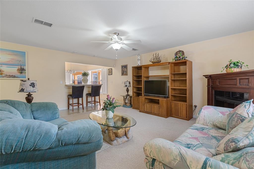 4190 Southwest 103rd Street Road Ocala, FL 34476 - Photo 42 of 55 a living room with furniture and a flat screen tv
