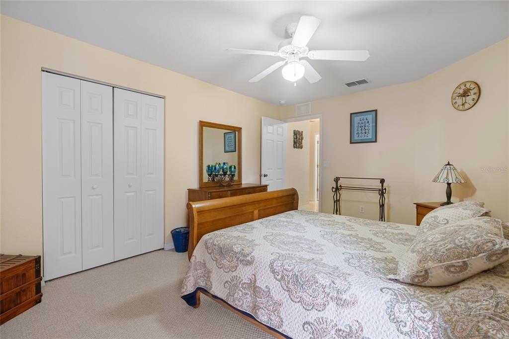 4190 Southwest 103rd Street Road Ocala, FL 34476 - Photo 47 of 55 a bedroom with a bed and a chandelier