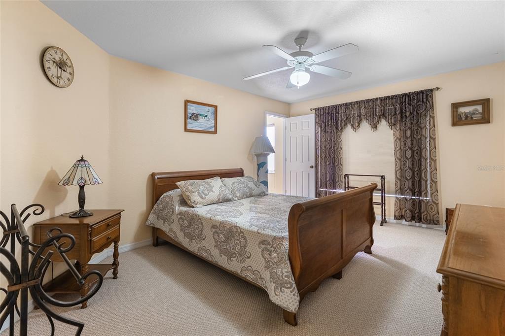 4190 Southwest 103rd Street Road Ocala, FL 34476 - Photo 48 of 55 a bed room with a bed window and a chair