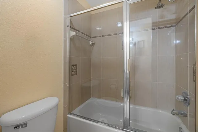 a bathroom with a tub a sink and a large mirror