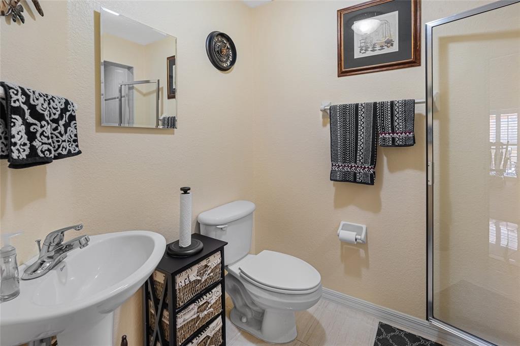 4190 Southwest 103rd Street Road Ocala, FL 34476 - Photo 53 of 55 a bathroom with a toilet a sink and mirror
