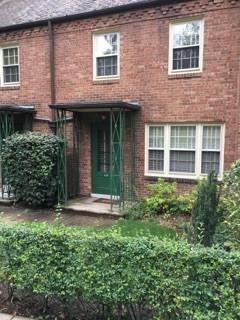 628 Olympia Road Pittsburgh, PA 15211 - Photo 1 of 15 a view of a brick house with plants and large windows