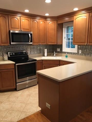628 Olympia Road Pittsburgh, PA 15211 - Photo 4 of 15 a kitchen with a sink and a microwave