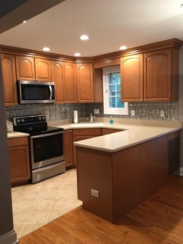 628 Olympia Road Pittsburgh, PA 15211 - Photo 5 of 15 a kitchen with a sink stove top oven and microwave