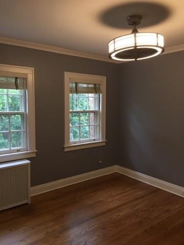 628 Olympia Road Pittsburgh, PA 15211 - Photo 6 of 15 a view of a room with wooden floor exposed radiator and windows