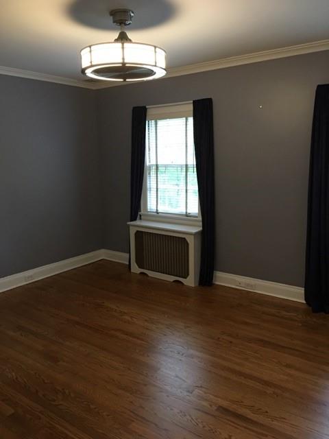 628 Olympia Road Pittsburgh, PA 15211 - Photo 7 of 15 a view of an empty room with wooden floor and a window