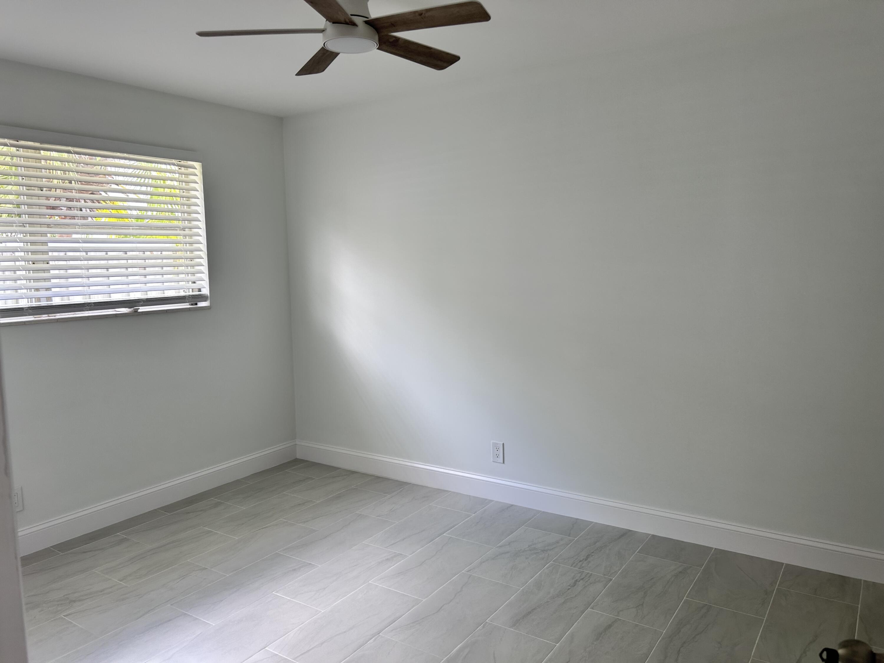 630 Prosperity Farms Road, Unit 2 North Palm Beach, FL 33408 - Photo 13 of 13 an empty room with a window
