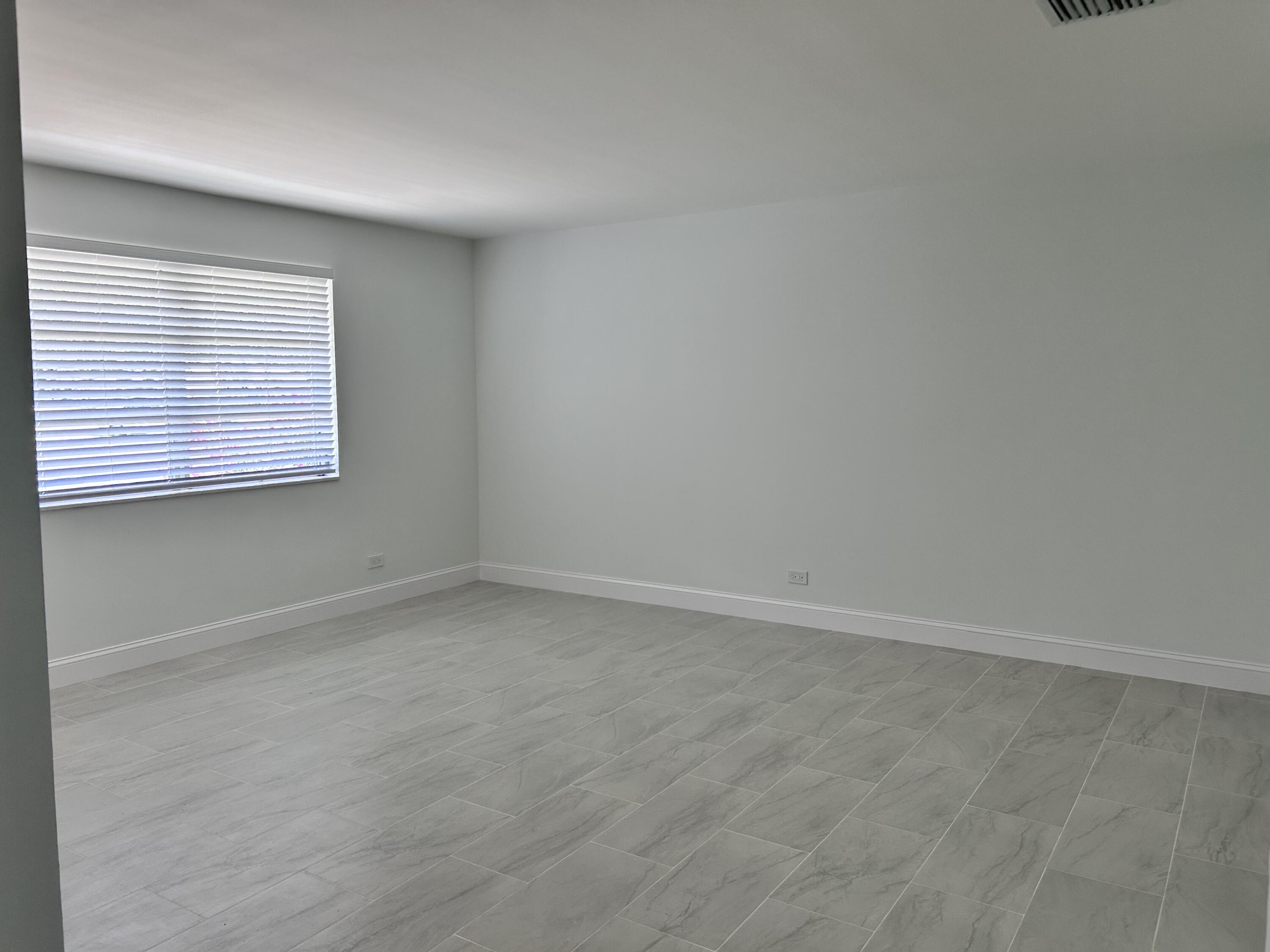 630 Prosperity Farms Road, Unit 2 North Palm Beach, FL 33408 - Photo 7 of 13 an empty room with a window