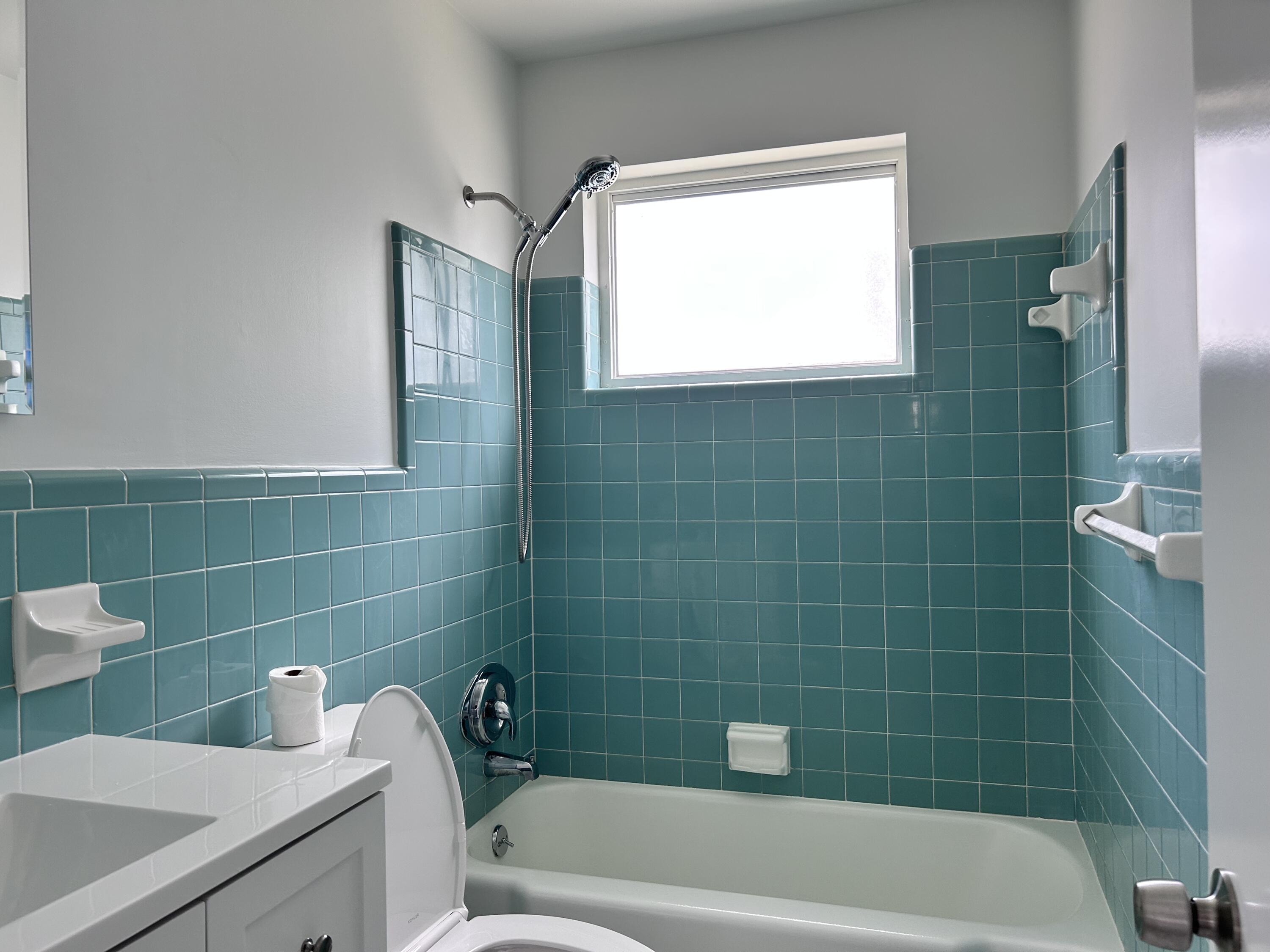 630 Prosperity Farms Road, Unit 2 North Palm Beach, FL 33408 - Photo 9 of 13 a bathroom with a bathtub sink and toilet