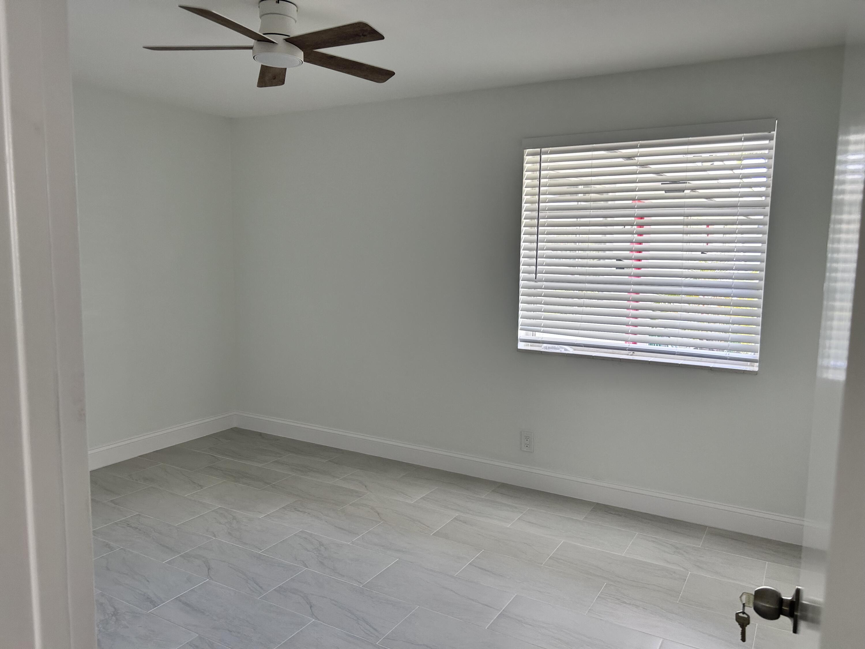 630 Prosperity Farms Road, Unit 2 North Palm Beach, FL 33408 - Photo 10 of 13 an empty room with a window