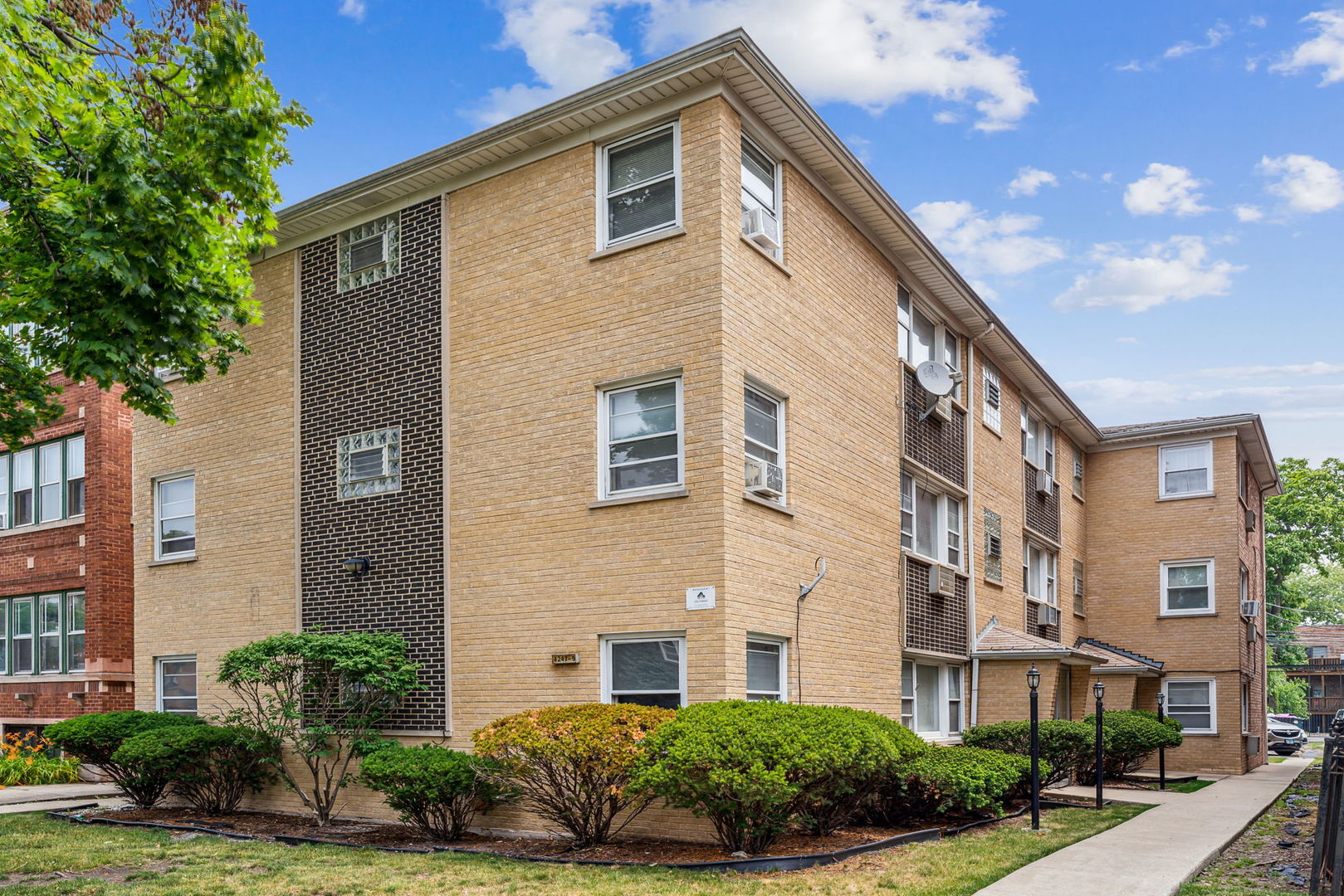 4247 North Keystone Avenue, Unit 1 Chicago, IL 60641 - Photo 1 of 18 a front view of a residential houses with yard and green space