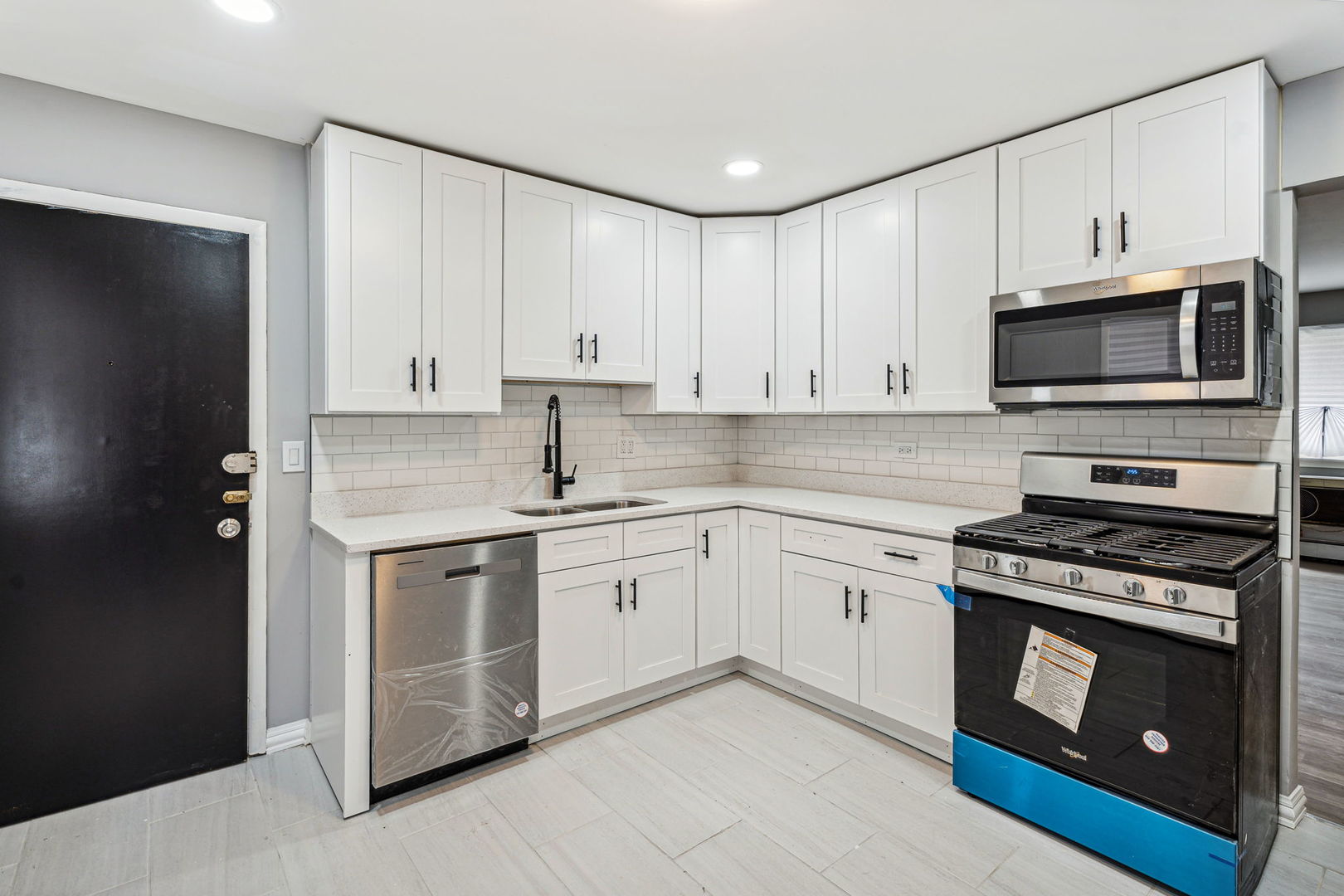 4247 North Keystone Avenue, Unit 1 Chicago, IL 60641 - Photo 4 of 18 a kitchen with cabinets stainless steel appliances and wooden floor