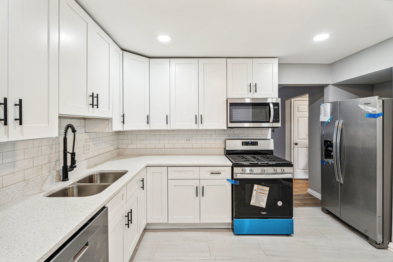 4247 North Keystone Avenue, Unit 1 Chicago, IL 60641 - Photo 6 of 18 a kitchen with cabinets stainless steel appliances and a sink