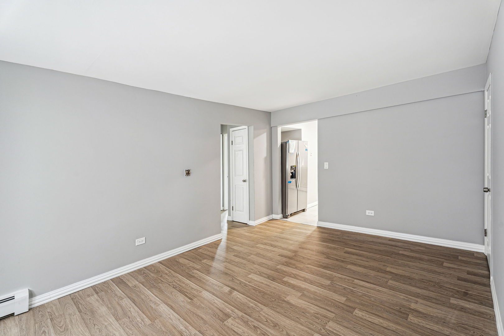 4247 North Keystone Avenue, Unit 1 Chicago, IL 60641 - Photo 8 of 18 a view of an empty room with wooden floor