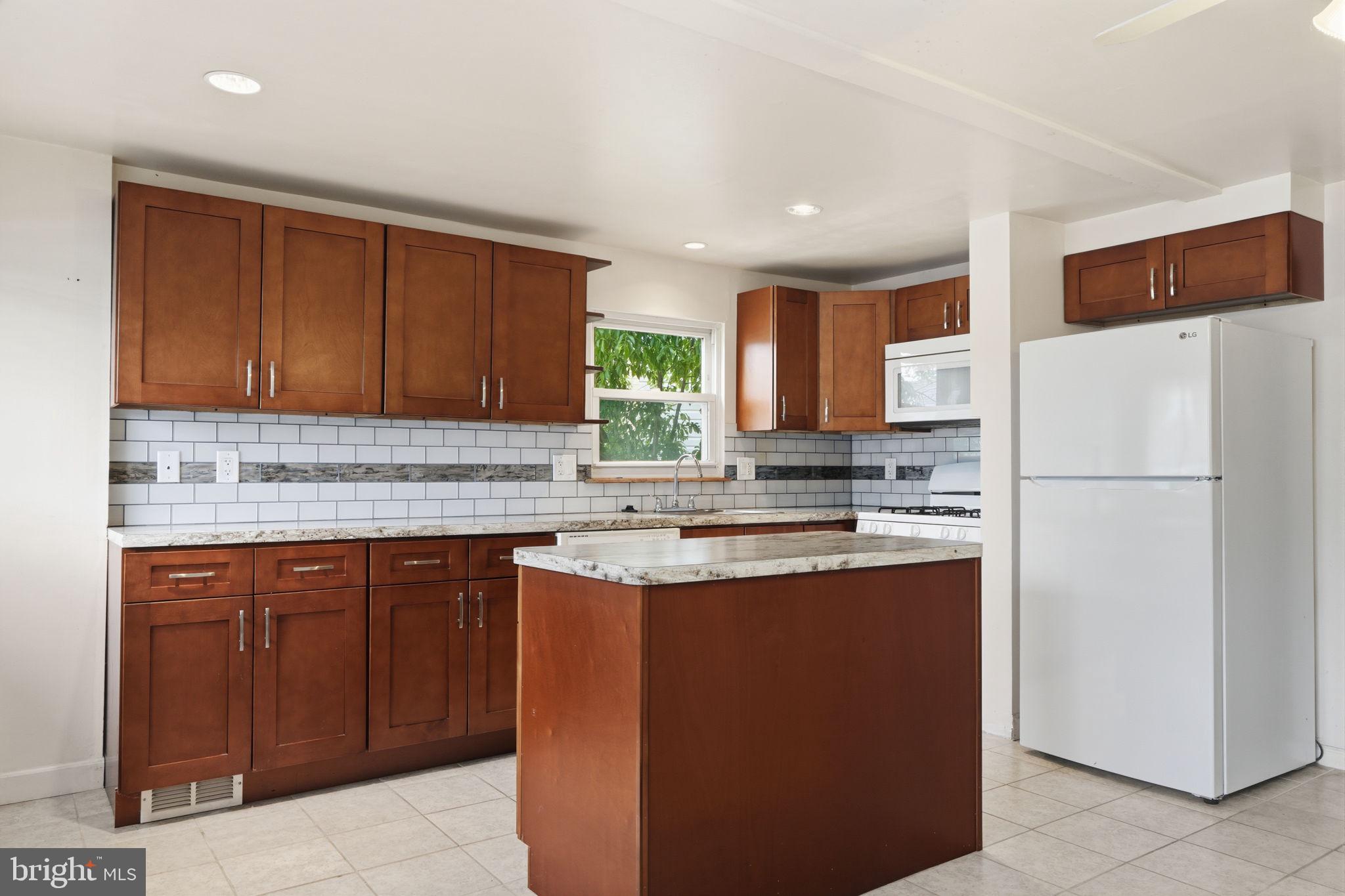 2838 Shipley Road Philadelphia, PA 19152 - Photo 6 of 24 Modern kitchen with rich wood accents.