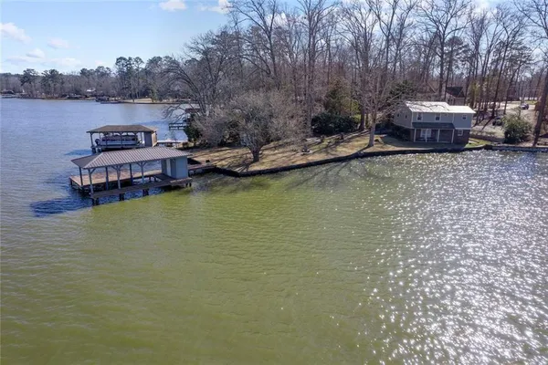 an aerial view of a house with a lake view
