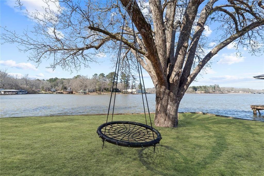 121 Little Riverview Road Eatonton, GA 31024 - Photo 13 of 53 a backyard of a house with lots of green space and lake view