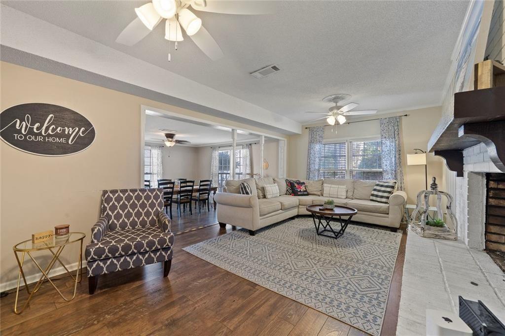 121 Little Riverview Road Eatonton, GA 31024 - Photo 19 of 53 a living room with furniture and a chandelier