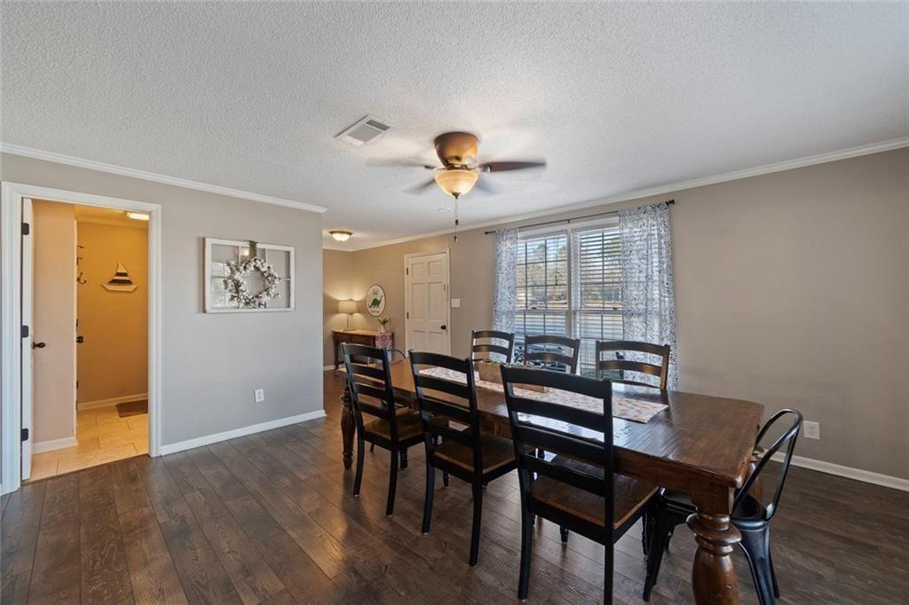 121 Little Riverview Road Eatonton, GA 31024 - Photo 24 of 53 a view of a dining room with furniture and wooden floor