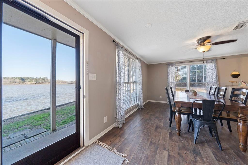 121 Little Riverview Road Eatonton, GA 31024 - Photo 26 of 53 a view of a dining room with furniture window and wooden floor