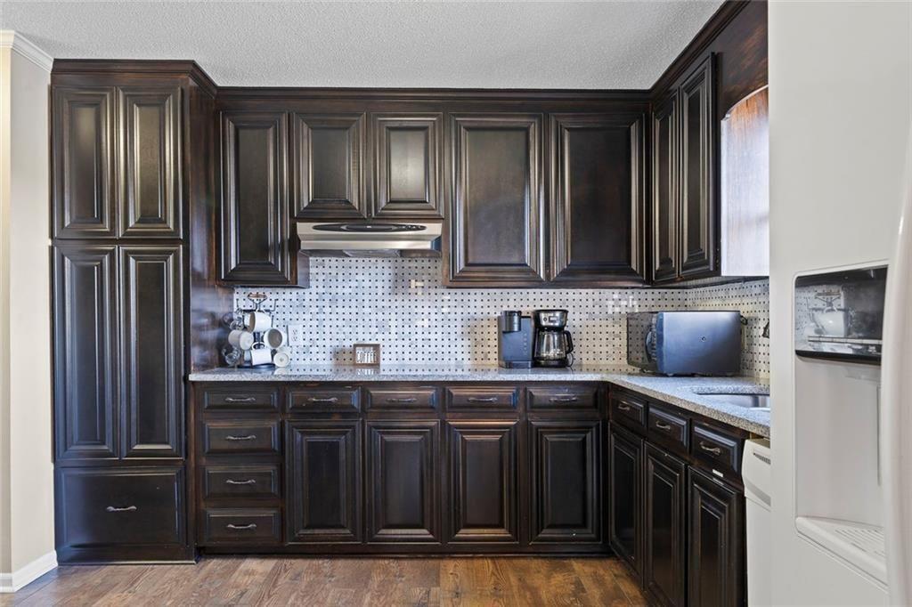 121 Little Riverview Road Eatonton, GA 31024 - Photo 29 of 53 a kitchen with stainless steel appliances granite countertop a refrigerator and a sink